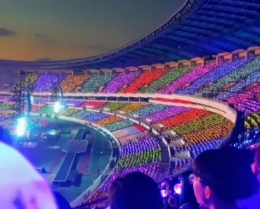 people-in-stadium-cheering-up-with-lightsticks-in-their-hand
